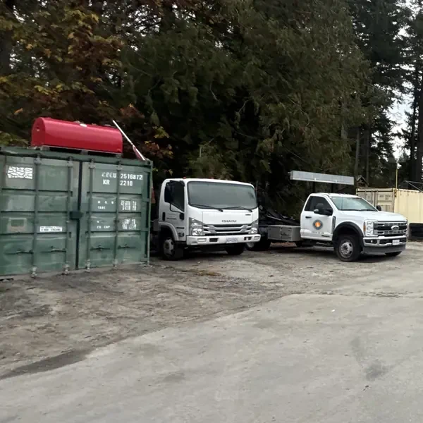 Transfer station entrance on Blackburn Rd, Salt Spring Island, with both bin trucks and the scale house