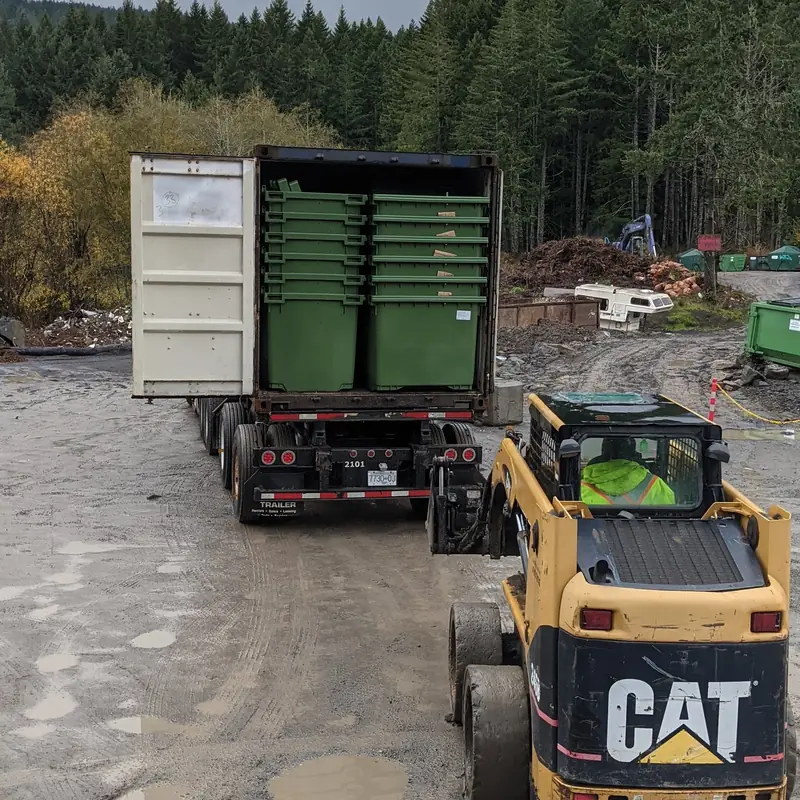 New green commercial garbage bins for Salt Spring Island businesses being unloaded at the Salt Spring Garbage yard