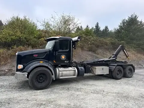 Black Peterbilt hook-lift truck with the Salt Spring Garbage & Recycling decal